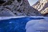 the zanskar river gushing its way through the ice